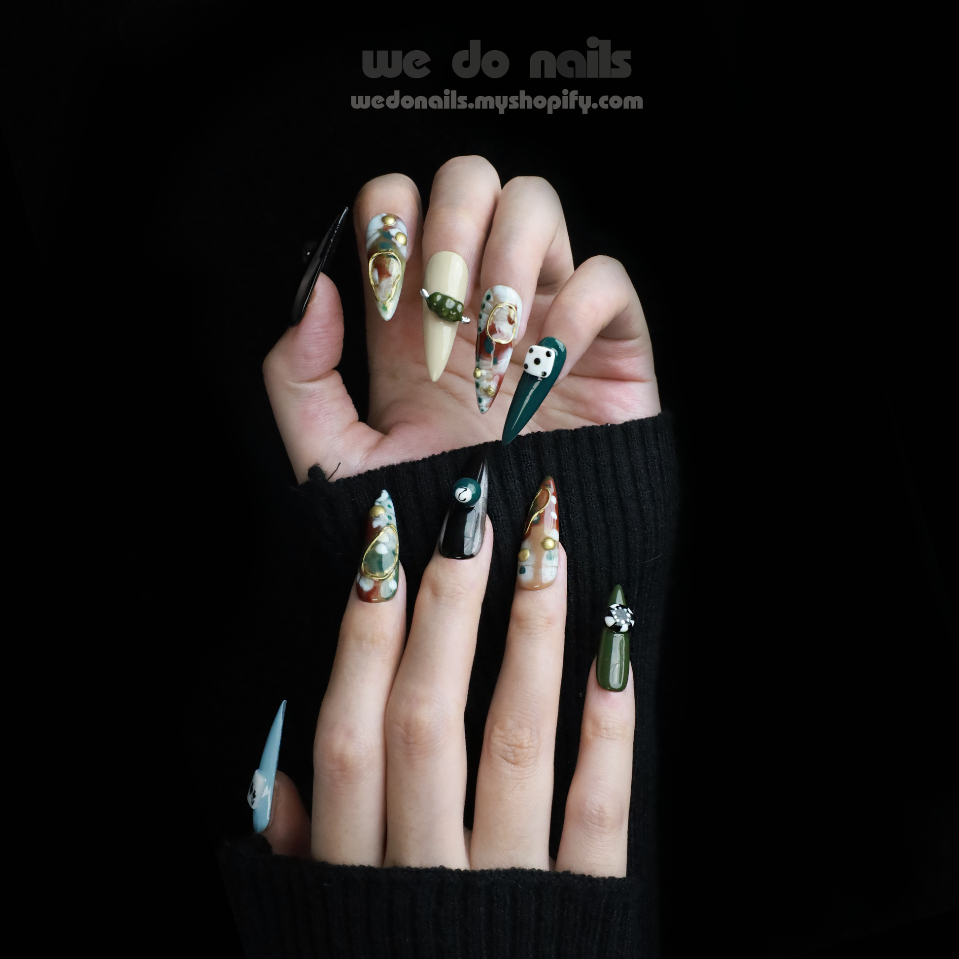 A person displays We Do Nails’ Game Night Press-On Nails, featuring long, intricately designed patterns in beige, black, and green while holding a white mug. A pink SHIP NEXT DAY label appears at the top left. Ideal for your next Game Night Glam!.